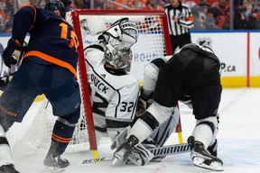 L.A. Kings' Anze Kopitar (11) hits goaltender Jonathan Quick (32) while playing the Edmonton Oilers during first period NHL Stanley Cup playoffs action at Rogers Place in Edmonton, on Saturday, May 14, 2022.