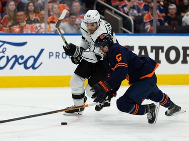 Edmonton Oilers' Kris Russell (6) is knocked down by L.A. Kings' Andreas Athanasiou (22) during second period NHL Stanley Cup playoffs action at Rogers Place in Edmonton, on Saturday, May 14, 2022.