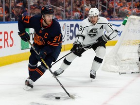 Edmonton Oilers' Connor McDavid (97) battles L.A. Kings' Dustin Brown (23) during third period NHL Stanley Cup playoffs action at Rogers Place in Edmonton, on Saturday, May 14, 2022.