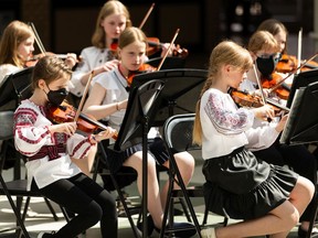 Musicians from the Young St. Martin Children's Strings Society perform at Bonnie Doon Mall in Edmonton, Sunday, May 15, 2022. The performance was part of Boonie Doon Mall's Peace Train initiative, where donations were accepted for Firefighter Aid Ukraine.