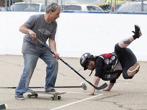 Skateboarders play a game of skate hockey, a modified version of road hockey that uses an empty Sapporo beer can instead of a puck, at the Ritchie Community League, 7727 98 St., in Edmonton Sunday May 29, 2022.