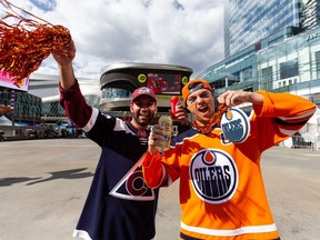 Thomas Khalaf, left, wearing Colorado Avalanche's alternate captain Nathan MacKinnon's jersey, and Cooper Wilde, wearing Edmonton Oilers' captain Connor McDavid's jersey, party outside of Rogers Place before the team's Game One away game versus the Colorado Avalanche in the Western Conference Finals of the Stanley Cup Playoffs in Edmonton, on Tuesday, May 31, 2022.