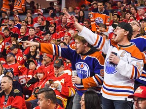 Edmonton Oilers fans celebrate after Zach Hyman #18 scored against the Calgary Flames during the second period of Game One of the Second Round of the 2022 Stanley Cup Playoffs at Scotiabank Saddledome on May 18, 2022 in Calgary.