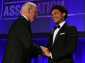 US President Joe Biden (L) shakes hands with South African comedian Trevor Noah during the White House Correspondents Association gala at the Washington Hilton Hotel in Washington, DC, on April 30, 2022.