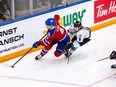 Edmonton Oil Kings defenceman Kaiden Guhle, left, is chased behind the net by Winnipeg ICE forward Zachary Benson in Game 2 of the WHL Eastern Conference Final at the Wayne Fleming Arena in Winnipeg on May 21, 2022.