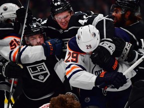 Los Angeles Kings defenseman Mikey Anderson (44) grabs Edmonton Oilers center Leon Draisaitl (29) as right wing Kailer Yamamoto (56) grabs defenseman Matt Roy (3) during the first period of Game 6 of the 2022 Stanley Cup Playoffs First Round at Crypto.com Arena.
