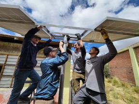 NAIT alternative energy students Ayrton Blank, left, Logan Hoyland, Thomas Black and Duncan Chan mount solar modules  in Ccollpapata, Peru, last month