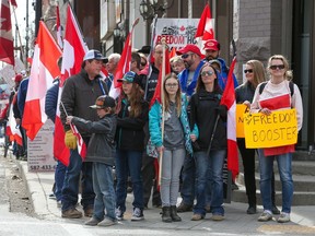 FILE PHOTO: Anti-mandate protesters wait at a light while walking to Calgary City Hall on Saturday, March 19, 2022. The protesters met in Central Memorial Park and then walked on the sidewalks to City Hall.