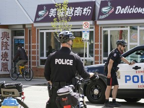 Police patrol the downtown Edmonton Chinatown district on Thursday May 26, 2022 after two recent homicides in the area.