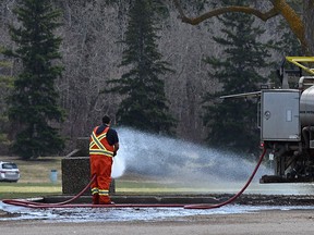 A worker does spring cleaning, pulverizing grunge accumulated over the winter at Hawrelak Park in Edmonton, April 29, 2022. Ed Kaiser/Postmedia