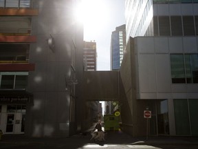 People walk their dogs through downtown Edmonton, Monday May 16, 2022.