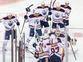 May 26, 2022; Calgary, Alberta, CAN; Edmonton Oilers center Connor McDavid (97) celebrates his goal with teammates during the first overtime period against the Calgary Flames in game five of the second round of the 2022 Stanley Cup Playoffs at Scotiabank Saddledome.