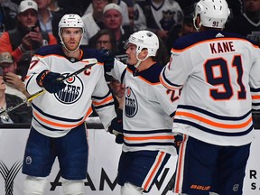 May 12, 2022; Los Angeles, California, USA; Edmonton Oilers center Connor McDavid (97) celebrates with defenseman Brett Kulak (27) and left wing Evander Kane (91) his goal scored against the Los Angeles Kings during the first period in game six of the first round of the 2022 Stanley Cup Playoffs at Crypto.com Arena.