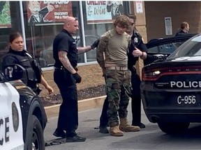 A man is detained following a mass shooting in the parking lot of TOPS supermarket, in a still image from a social media video in Buffalo, New York, U.S. May 14, 2022.  Courtesy of BigDawg/ via REUTERS