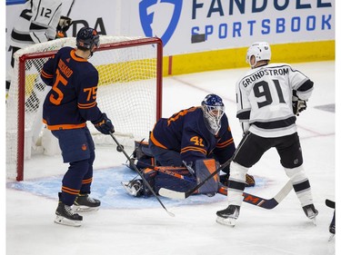 The puck slides past Edmonton Oilers goaltender Mike Smith (41) as Carl Grundstrom (91) and Evan Bouchard (75) watch the Los Angeles Kings score during first period NHL playoff action on Tuesday, May 10, 2022 in Edmonton.