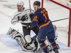 Edmonton Oilers Jesse Puljujarvi (13) fights Los Angeles Kings Matt Roy (3) in front of goaltender Jonathan Quick (32) during NHL first period playoff action on Tuesday, May 10, 2022 in Edmonton .