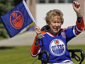 Edmonton Oilers fan Naomi Beck cheers on her team outside her home in west Edmonton on Monday, May 30, 2022. The 91-year-old COVID-19 survivor, is waiting in anticipation for the first game of the conference final between the Edmonton Oilers and Colorado Avalanche which will be played on Tuesday, May 31, 2022.