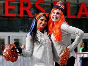 Edmonton Oilers tailgate party employees Henna Sahota, left, and Rebecca Jayne stand outside Rogers Place as they wait for the start of Game 5 between the Oilers and Los Angeles Kings, in Edmonton Tuesday, May 10, 2022.