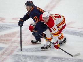 Edmonton Oilers Ryan McLeod (71) collides with Calgary Flames Mikael Backlund (11) during first period NHL second round playoff hockey action on Sunday, May 22, 2022 in Edmonton.