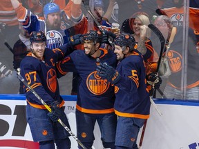 Edmonton Oilers Evander Kane (91) celebrates his first goal with teamates Connor McDavid (97) and Cody Ceci (5) against the Calgary Flames during second period NHL second round playoff hockey action on Sunday, May 22, 2022 in Edmonton.