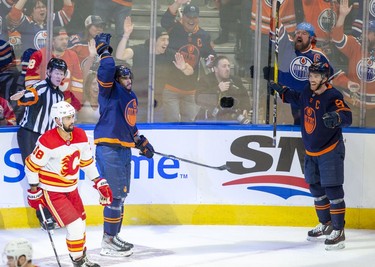 Edmonton Oilers Evander Kane (91) celebrates his third goal of the period with teammate Connor McDavid (97) against the Calgary Flames during second period NHL second round playoff hockey action on Sunday, May 22, 2022 in Edmonton.
