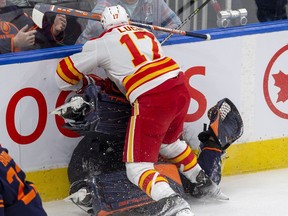 Edmonton Oilers goaltender Mike Smith (41) is hit by Calgary Flames Milan Lucic (17) during third period NHL second round playoff hockey action on Sunday, May 22, 2022.