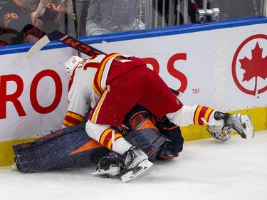 Edmonton Oilers goaltender Mike Smith (41) is pushed over by Calgary Flames Milan Lucic (17) during third period NHL second round playoff hockey action on Sunday, May 22, 2022 in Edmonton.