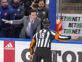 Head coach Jay Woodcroft has a word with the referee after Edmonton Oilers goaltender Mike Smith (41) is pushed over by Calgary Flames Milan Lucic (17) during third period NHL second round playoff hockey action on Sunday, May 22, 2022 in Edmonton.