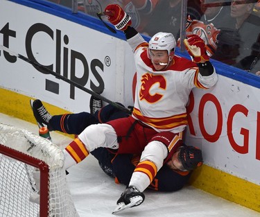 Edmonton Oilers Ryan McLeod (71) gets sat on by Calgary Flames Nikita Zadorov (16) during NHL playoff action at Rogers Place in Edmonton, May 24, 2022.