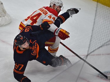 Edmonton Oilers Connor McDavid (97) gets upended by Calgary Flames Erik Gudbranson (44) during NHL playoff action at Rogers Place in Edmonton, May 24, 2022.