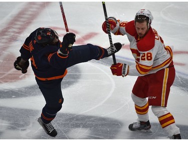 Edmonton Oilers Evander Kane (91) and Calgary Flames Elias Lindholm (28) collide at centre ice during NHL playoff action at Rogers Place in Edmonton, May 24, 2022.