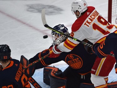 Edmonton Oilers goalie Mike Smith (41) makes the save as Calgary Flames Matthew Tkachuk (19) tries for the rebound during NHL playoff action at Rogers Place in Edmonton, May 24, 2022.