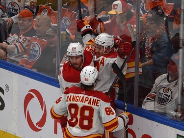 Calgary Flames Mikael Backlund (11) celebrates his goal with Andrew Mangiapane (88) and Blake Coleman (20) against the Edmonton Oilers during NHL playoff action at Rogers Place in Edmonton, May 24, 2022.