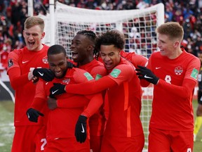 Canada's Junior Hoilett celebrates scoring with teammates in a World Cup Qualifier at BMO Field in Toronto on March 27, 2022.