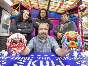 Documentary maker Fernando Cienfuegos, seated, brought sugar skull artists, left standing, Araceli Lopez and Brandon Rodriguez de Paz, and social media expert Angel Mejia,, right, to Canada for a demonstration and a talk at the Edmonton Public library.