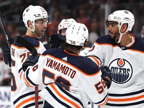 Evan Bouchard (75) of the Edmonton Oilers celebrates his goal with Duncan Keith (2), Kailer Yamamoto (56) and Evander Kane (91) to take a 3-1 lead over the Los Angeles Kings, during a 3-2 Oilers win at Crypto.com Arena on April 07, 2022, in Los Angeles.
