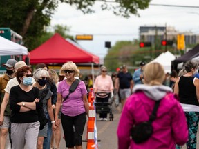 Shoppers, some wearing COVID-19 masks, attend the Sunday edition of the 124 Grand Market along 102 Avenue near 124 Street in Edmonton, on Sunday, July 4, 2021.