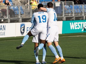 FC Edmonton’s Mamadi Camara (6) celebrates a goal with teammates on Forge FC’s goalkeeper Triston Henry (1) during first half Canadian Premier League soccer action at Clarke Stadium in Edmonton, on Tuesday, May 31, 2022.