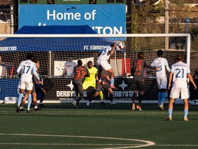 FC Edmonton’s Kairo Coore (45) scores on Forge FC’s goalkeeper Triston Henry (1) during second half Canadian Premier League soccer action at Clarke Stadium in Edmonton, on Tuesday, May 31, 2022.