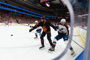 Edmonton Oilers' Zack Kassian (44) is held by Colorado Avalanche's Darren Helm (43) for a penalty during first period of Game 4 of the NHL Western Conference Final action at Rogers Place in Edmonton, on Monday, June 6, 2022.
