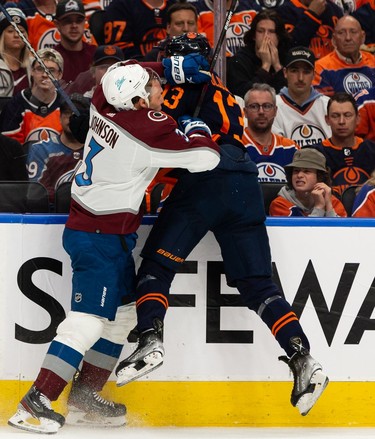 Edmonton Oilers' Jesse Puljujarvi (13) is hit by Colorado Avalanche's Jack Johnson (3) during first period of Game 4 of the NHL Western Conference Final action at Rogers Place in Edmonton, on Monday, June 6, 2022.
