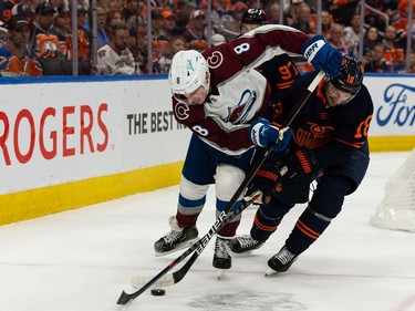 Edmonton Oilers' Zach Hyman (18) battles Colorado Avalanche's Cale Makar (8) during first period of Game 4 of the NHL Western Conference Final action at Rogers Place in Edmonton, on Monday, June 6, 2022.