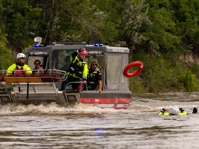 Edmonton Fire Rescue Service firefighters demonstrate a river rescue on the North Saskatchewan River near Wilfred Laurier Park boat launch in Edmonton on Wednesday, Nov. 29, 2022. City of Edmonton Park Rangers, Edmonton Fire Rescue Services, Edmonton Police Service and RCMP are asking the public to be safe around water and the North Saskatchewan River as Canada Day approaches.