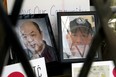 Photographs of Ban Phuc Hoang, 61, and Hung Trang, 64, two slain members of Edmonton's Chinatown community,  are displayed in a shop window in Edmonton's Chinatown on June 1, 2022.
