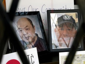 Photographs of Ban Phuc Hoang, 61, and Hung Trang, 64, two slain members of Edmonton's Chinatown community,  are displayed in a shop window in Edmonton's Chinatown on June 1, 2022.