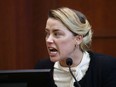 Amber Heard reacts as she testifies during a defamation case against her by ex-husband, actor Johnny Depp in Fairfax, Virginia, U.S., May 5, 2022.