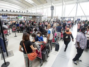 More travellers wait in line at Toronto Pearson Airport's Terminal 1, May 9, 2022.