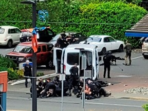 A view of the site where two armed suspects died and six police officers were shot, during an incident at a bank in Saanich, B.C., June 28, 2022.
