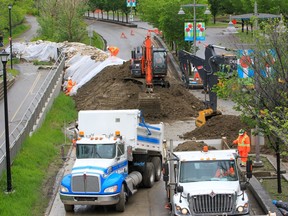 City of Calgary crews build an earth berm across Memorial Drive as flood protection on Tuesday, June 14, 2022.