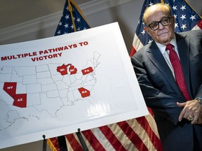 Rudy Giuliani stands next to a map during a news conference about various lawsuits related to the 2020 election, inside the Republican National Committee headquarters on November 19, 2020 in Washington, DC.